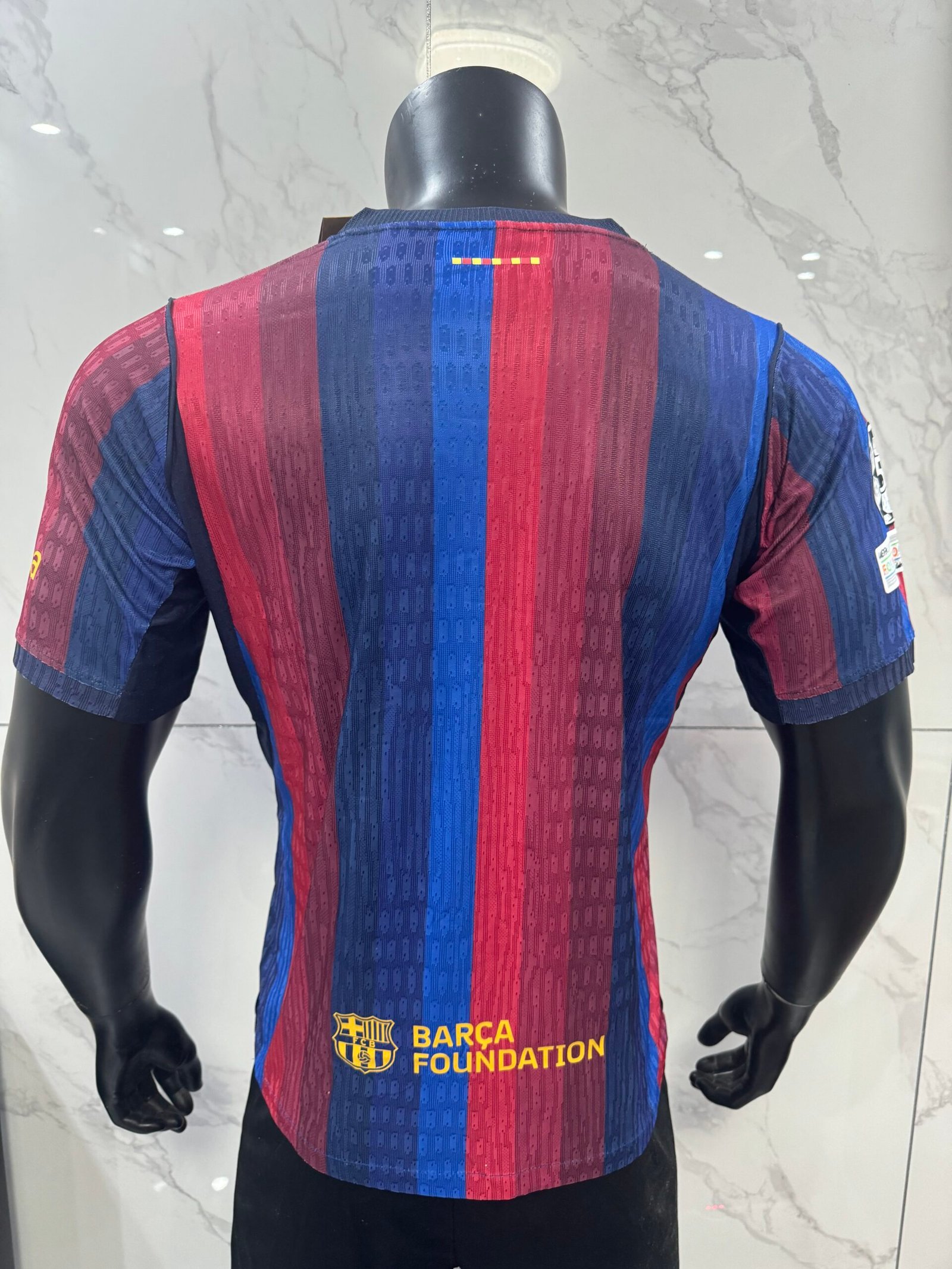 Alternative view of 26-27 Barcelona wearing Champions League armband at home