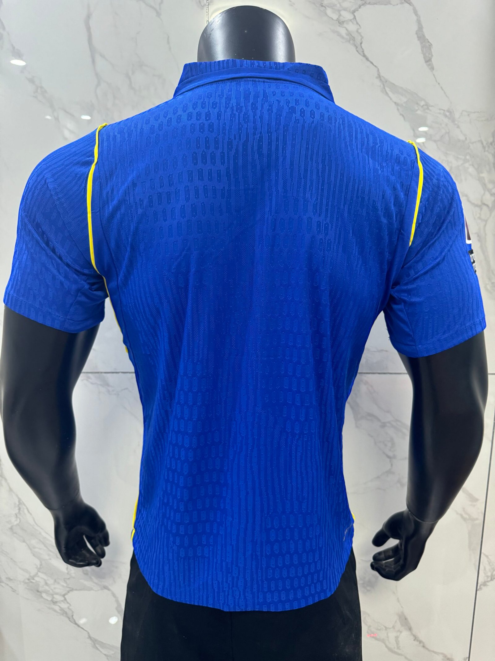 Alternative view of Player 26-27 Chelsea wearing Premier League plush armband at home