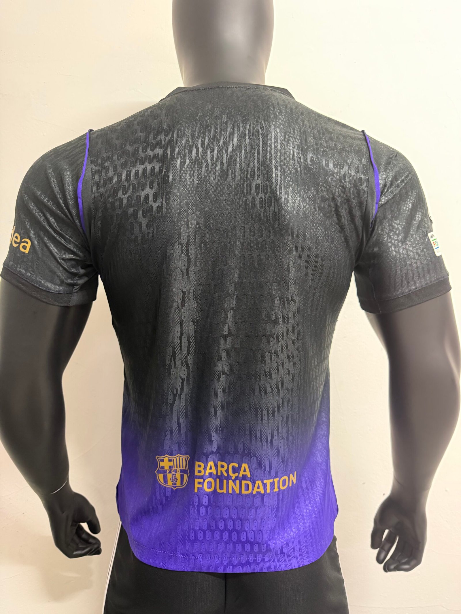 Alternative view of Player 26-27 Barcelona away wearing Champions League armband